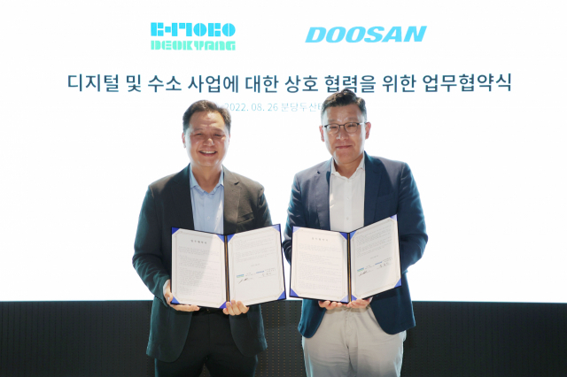 송용진 두산에너빌리티 전략혁신부문장(오른쪽)과 제임스 김 덕양 대표이사가 26일 경기도 분당두산타워에서 열린 ‘디지털 및 수소 사업에 대한 상호 협력을 위한 업무 협약식’에서 기념촬영을 하고 있다. <사진제공=두산에너빌리티>