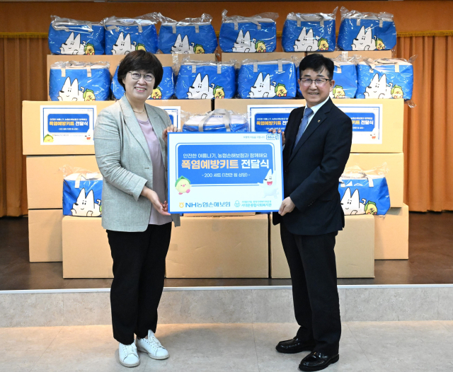 지난 17일 송춘수 NH농협손보 대표이사(오른쪽)와 정미령 서대문종합사회복지관장(왼쪽)이 기념사진 촬영을 하고 있다. <사진=NH농협손보>